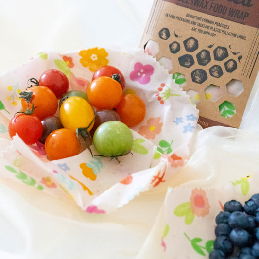 Cherry tomatoes and blueberries arranged on Superwrap’s upcycled beeswax wrap in the ‘Petal Palette’ design
